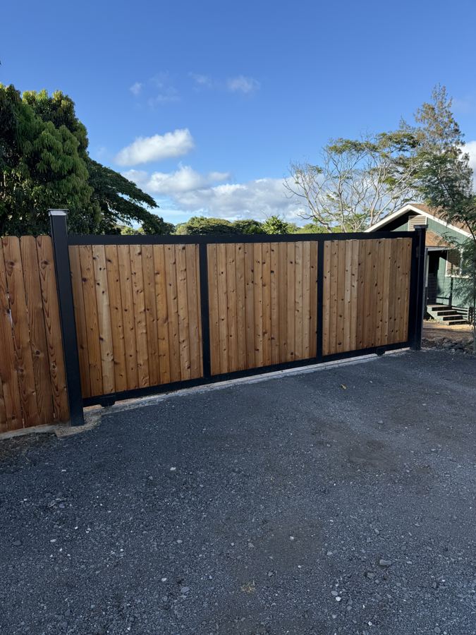 Wood slat driveway gate with black steel frame